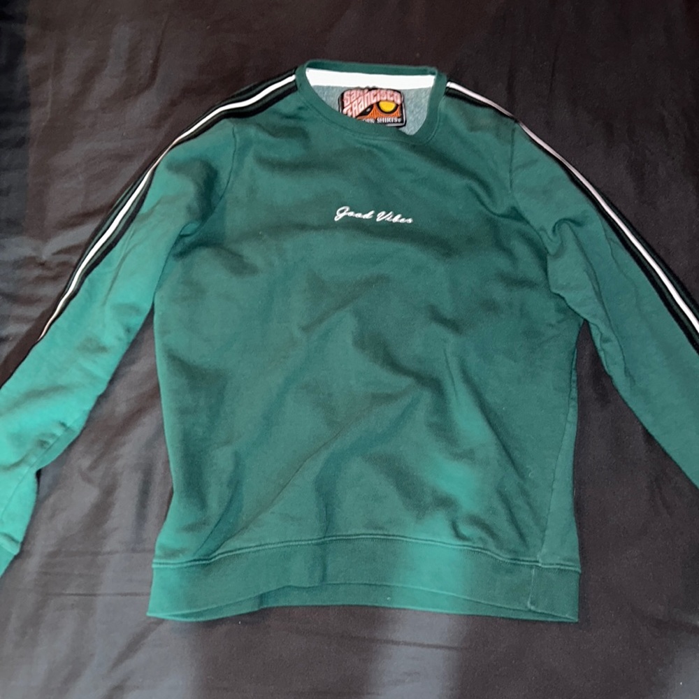 Long sleeve crew neck green sweater .
